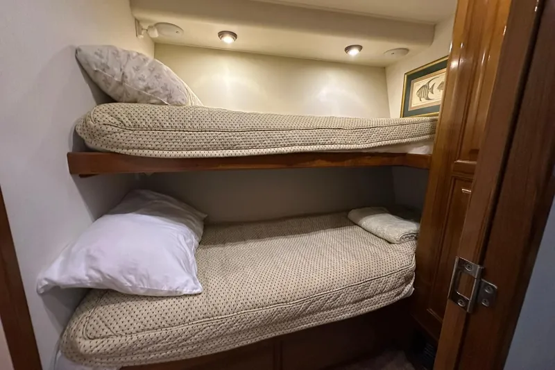 So Blessed Yacht Photos Pics Bunk beds in 1998 Viking 54 Motor Yacht cabin, cozy and well-lit interior.
