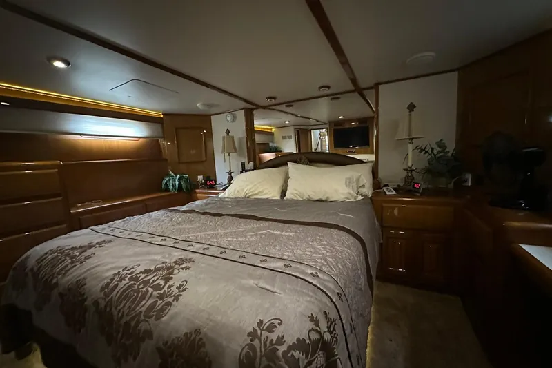 So Blessed Yacht Photos Pics Luxurious bedroom interior of 1998 Viking 54 Motor Yacht with elegant bedding and wood finishes.