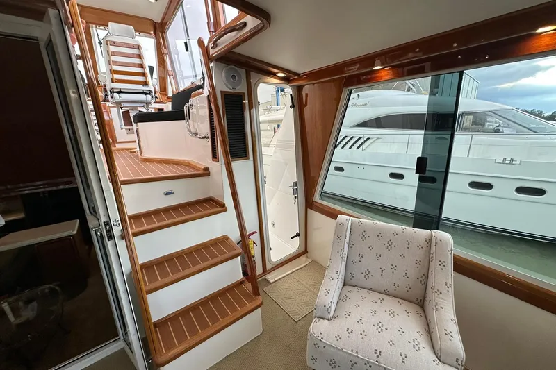 So Blessed Yacht Photos Pics Interior of 1998 Viking 54 Motor Yacht with stairs, chair, and large window view.