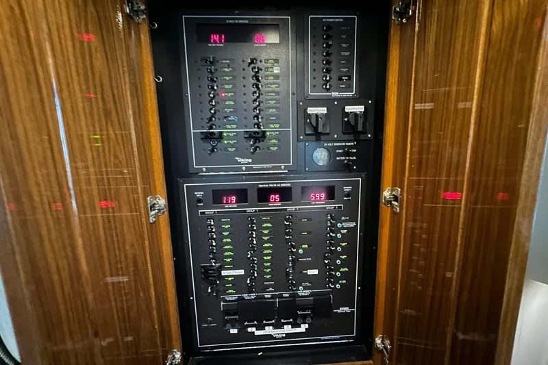 So Blessed Yacht Photos Pics Electrical control panel inside a 1998 Viking 54 Motor Yacht, featuring various switches and displays.
