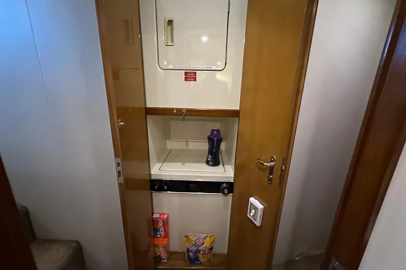 So Blessed Yacht Photos Pics Laundry area inside 1998 Viking 54 Motor Yacht with stacked washer and dryer.