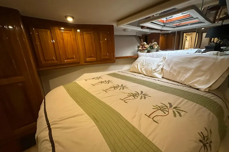 So Blessed Yacht Photos Pics Luxurious bedroom interior of 1998 Viking 54 Motor Yacht with elegant wood cabinetry.
