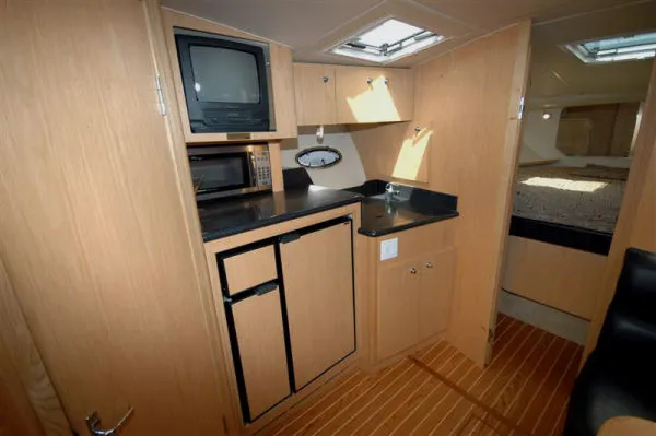 Vixen Yacht Photos Pics Interior of 2002 Tiara Yachts 3500 Open with kitchenette and sleeping area.