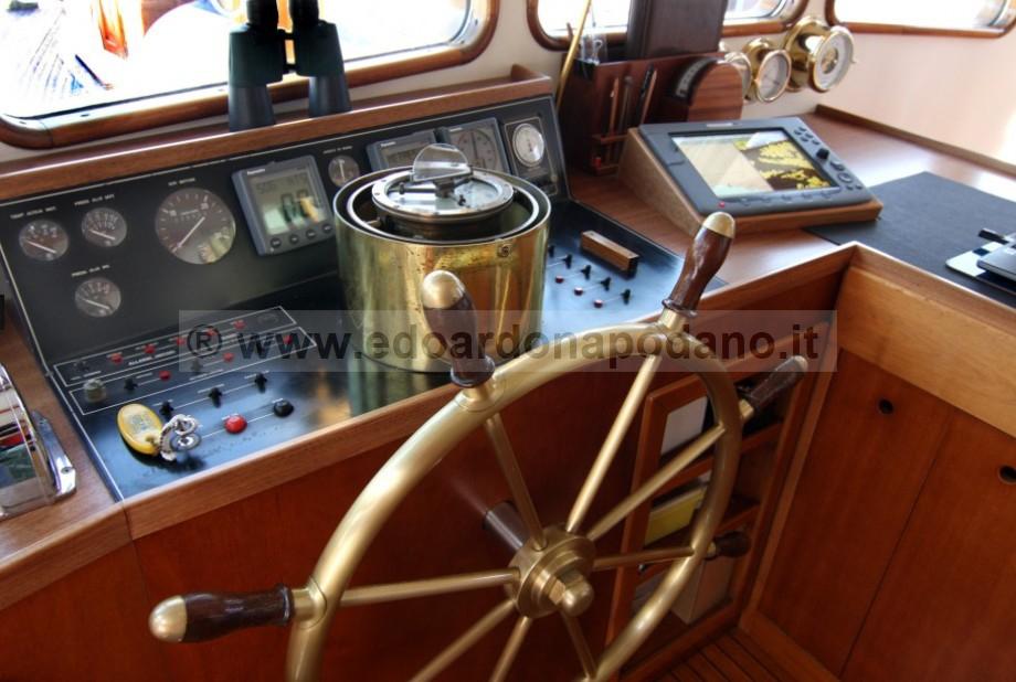 1925 Codecasa schooner helm with brass wheel, navigation instruments, and control panel.