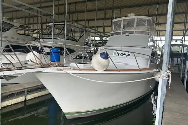  Yacht Photos Pics 1984 Post 43 Sport Fisherman boat docked in a covered marina.