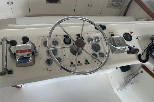  Yacht Photos Pics 1984 Post 43 Sport Fisherman boat helm with steering wheel and control panel.