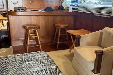  Yacht Photos Pics Interior of 1984 Post 43 Sport Fisherman with wooden bar, stools, and cozy seating area.