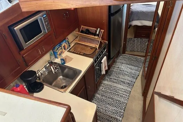  Yacht Photos Pics 1984 Post 43 Sport Fisherman yacht kitchen with sink, microwave, and stove.