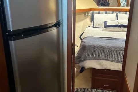  Yacht Photos Pics 1984 Post 43 Sport Fisherman interior with bed and refrigerator.