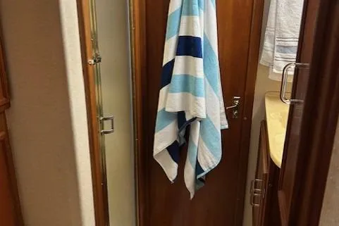  Yacht Photos Pics 1984 Post 43 Sport Fisherman bathroom with striped towel and shower.