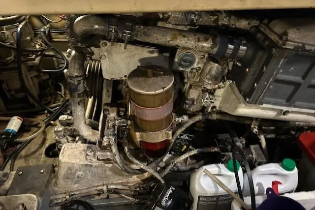  Yacht Photos Pics Engine room of a 1984 Post 43 Sport Fisherman boat, showing mechanical components and maintenance supplies.