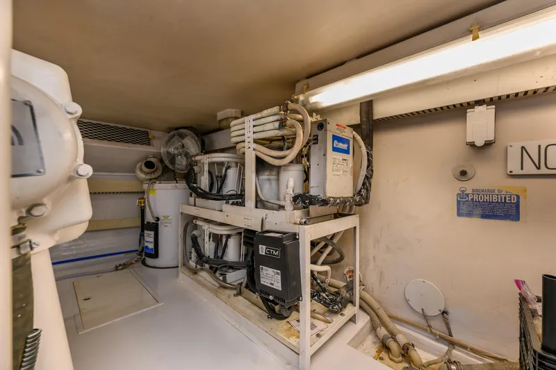 Marysea Yacht Photos Pics Engine room of 1999 Viking 58 Convertible yacht with mechanical equipment and piping.