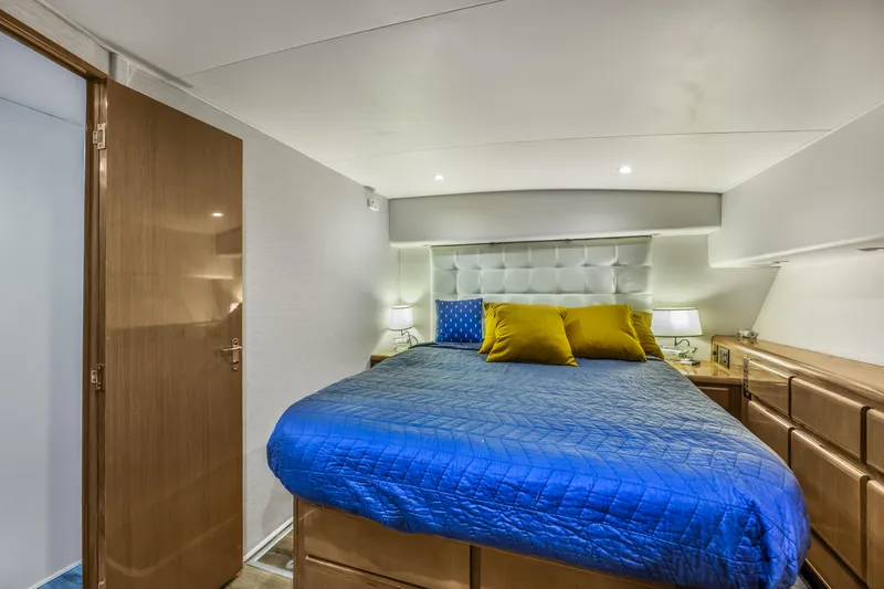 Marysea Yacht Photos Pics Luxurious bedroom interior of 1999 Viking 58 Convertible yacht with blue bedding and modern decor.
