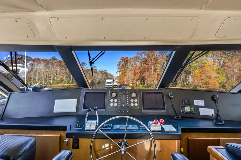 Marysea Yacht Photos Pics Interior view of 1999 Viking 58 Convertible yacht cockpit with scenic autumn background.