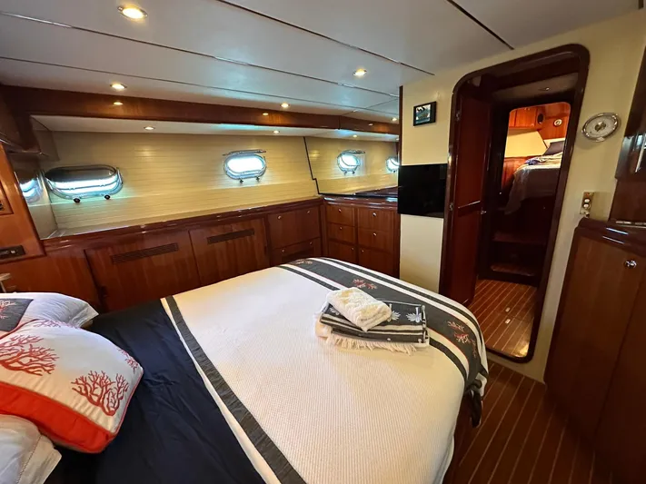 Beyond Capricorn 1 Yacht Photos Pics Luxurious cabin interior of a 2001 Nordhavn 57 yacht, featuring elegant wood finishes.