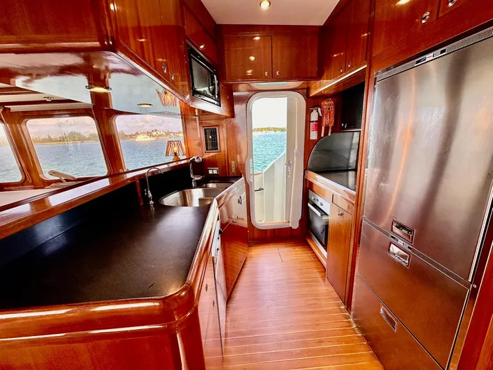 Beyond Capricorn 1 Yacht Photos Pics Luxurious 2001 Nordhavn 57 yacht kitchen with wood cabinetry and ocean view.