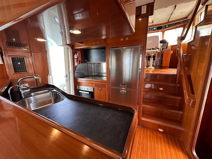 Beyond Capricorn 1 Yacht Photos Pics Luxurious 2001 Nordhavn 57 yacht interior with modern kitchen and wooden finishes.