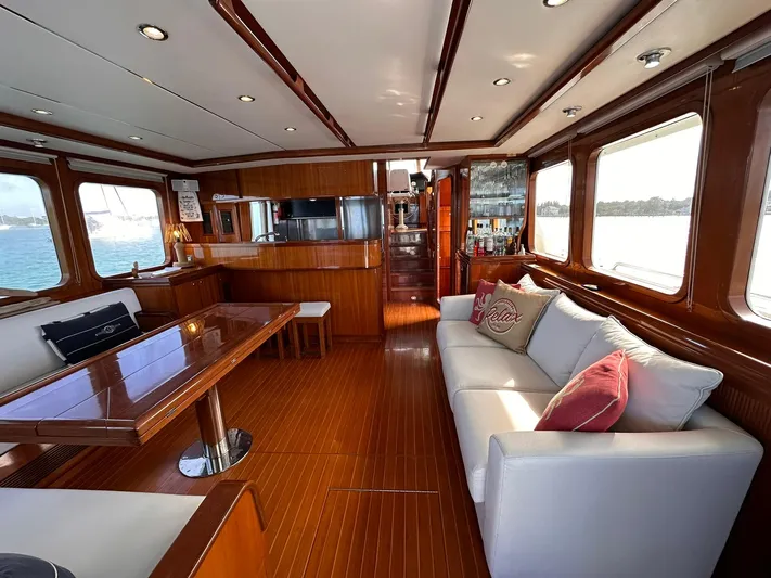 Beyond Capricorn 1 Yacht Photos Pics Luxurious interior of a 2001 Nordhavn 57 yacht with elegant wood finishes and comfortable seating.