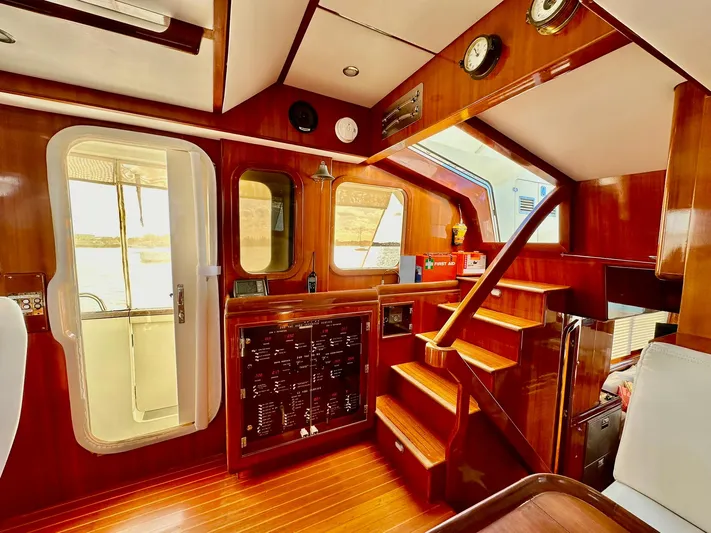 Beyond Capricorn 1 Yacht Photos Pics Luxurious 2001 Nordhavn 57 yacht interior with wooden finishes and staircase.