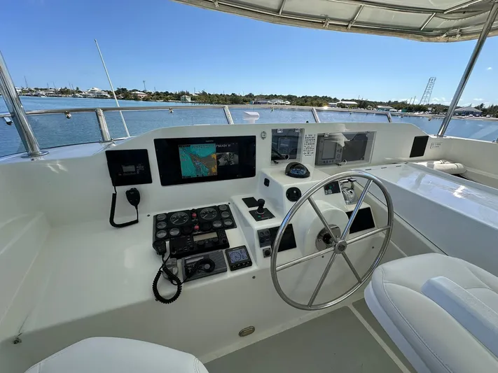 Beyond Capricorn 1 Yacht Photos Pics Helm of 2001 Nordhavn 57 yacht with navigation equipment and steering wheel.