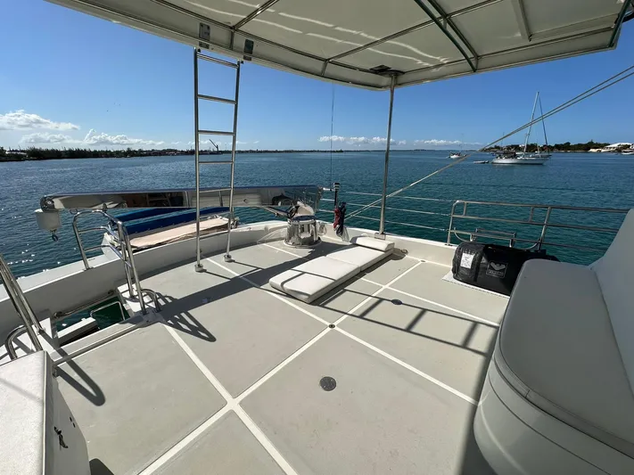 Beyond Capricorn 1 Yacht Photos Pics Nordhavn 57 yacht deck, 2001 model, overlooking serene waters and distant boats.