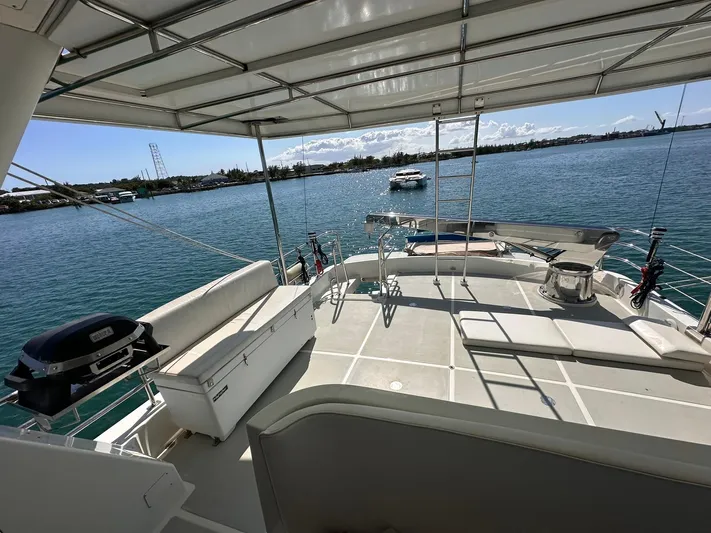 Beyond Capricorn 1 Yacht Photos Pics 2001 Nordhavn 57 yacht deck with seating, grill, and ocean view.