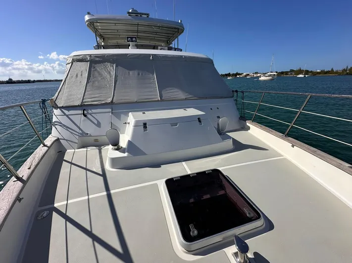 Beyond Capricorn 1 Yacht Photos Pics Nordhavn 57 yacht deck, 2001 model, with clear skies and calm waters in the background.