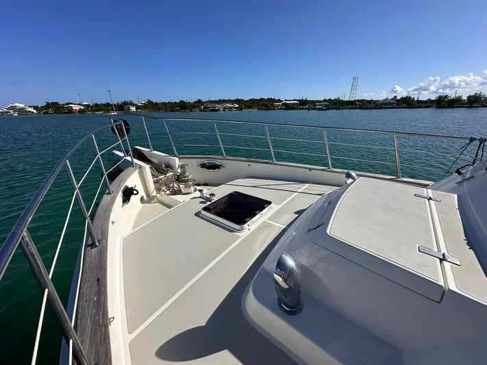Beyond Capricorn 1 Yacht Photos Pics Nordhavn 57 yacht deck, 2001 model, overlooking serene blue waters and distant shoreline.
