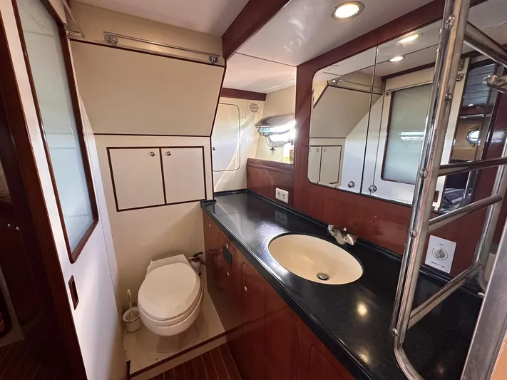 Beyond Capricorn 1 Yacht Photos Pics Luxurious bathroom in a 2001 Nordhavn 57 yacht with modern fixtures and wood accents.