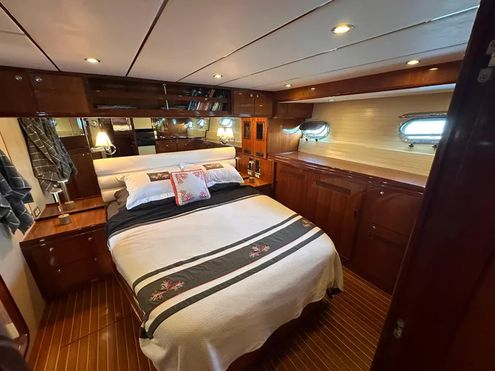 Beyond Capricorn 1 Yacht Photos Pics Luxurious 2001 Nordhavn 57 yacht bedroom with elegant wood finishes and cozy bedding.