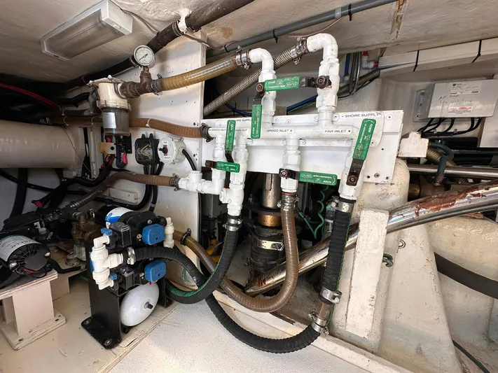 Beyond Capricorn 1 Yacht Photos Pics Engine room of a 2001 Nordhavn 57 yacht, showcasing complex piping and machinery.