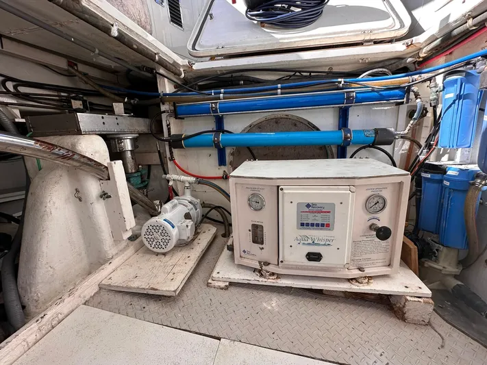 Beyond Capricorn 1 Yacht Photos Pics Engine room of a 2001 Nordhavn 57 yacht, featuring water filtration system and equipment.