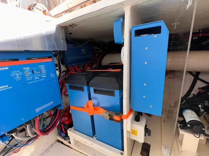 Beyond Capricorn 1 Yacht Photos Pics Engine room of 2001 Nordhavn 57 yacht with blue electrical components and wiring.