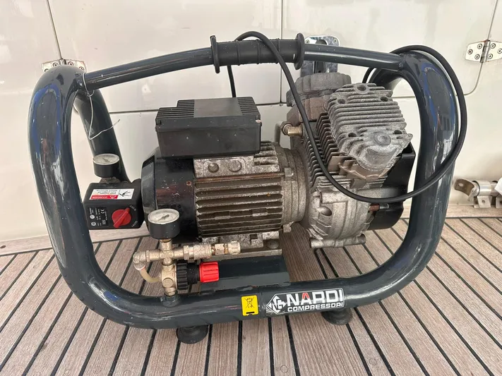 Beyond Capricorn 1 Yacht Photos Pics Portable Nardi compressor on a Nordhavn 57 yacht, 2001 model, placed on wooden deck.