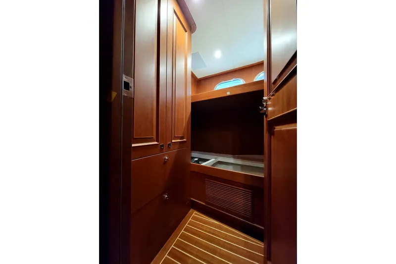 Oasis Yacht Photos Pics 2024 Northwest 55 yacht interior with wooden cabinetry and striped flooring.