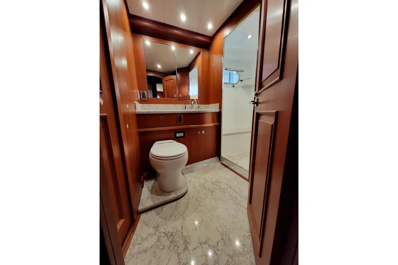 Oasis Yacht Photos Pics Luxurious bathroom in 2024 Northwest 55 yacht with marble flooring and wooden cabinetry.