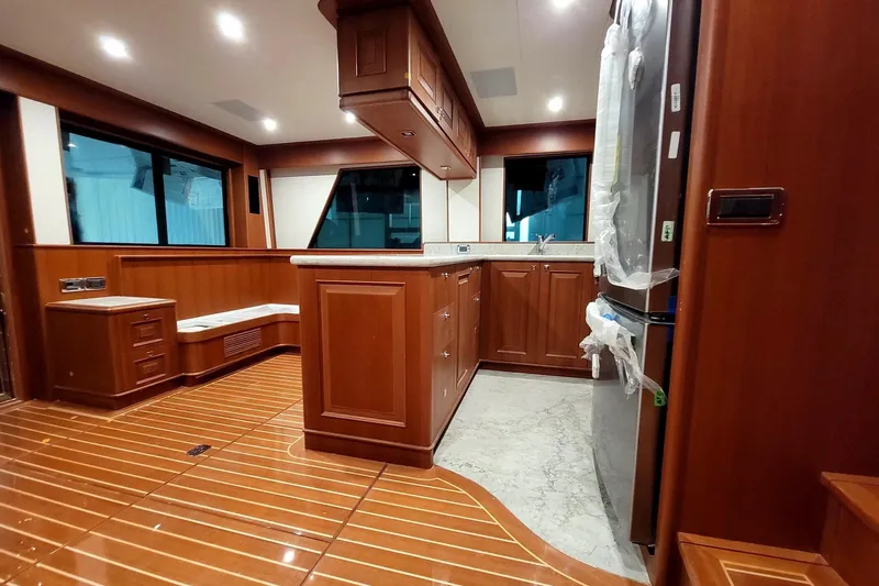 Oasis Yacht Photos Pics Luxurious 2024 Northwest 55 yacht interior with elegant wood finishes and modern kitchen amenities.