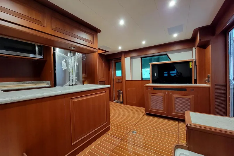 Oasis Yacht Photos Pics Luxurious interior of 2024 Northwest 55 yacht with wood finish and modern amenities.