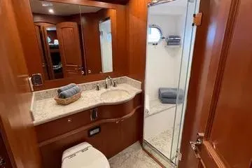 Oasis Yacht Photos Pics Luxurious bathroom in 2024 Northwest 55 yacht with wood accents and modern fixtures.