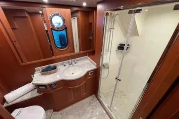 Oasis Yacht Photos Pics Luxurious bathroom in 2024 Northwest 55 yacht with modern shower and elegant wood finishes.