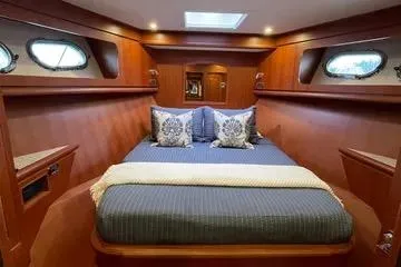 Oasis Yacht Photos Pics Luxurious cabin interior of 2024 Northwest 55 yacht with elegant wood finish.