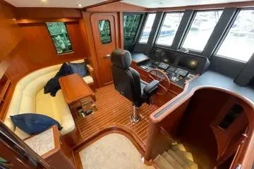 Oasis Yacht Photos Pics Luxurious interior of 2024 Northwest 55 yacht with wood finishes and modern helm.