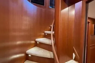 Oasis Yacht Photos Pics Elegant wooden spiral staircase in 2024 Northwest 55 yacht interior.