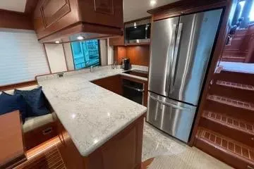 Oasis Yacht Photos Pics Luxurious kitchen interior of 2024 Northwest 55 yacht with modern appliances and elegant design.