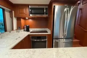 Oasis Yacht Photos Pics Modern kitchen in 2024 Northwest 55 model with stainless steel appliances and marble countertops.