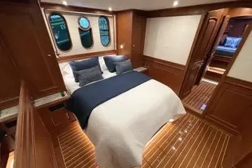 Oasis Yacht Photos Pics Luxurious cabin interior of 2024 Northwest 55 yacht with elegant wood finish.
