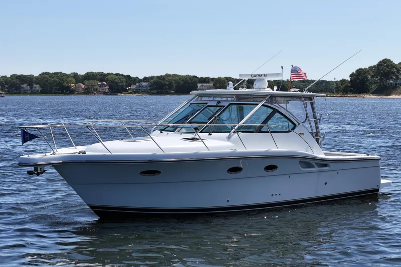 T-time Yacht Photos Pics 2006 Tiara 3200 Open yacht on calm water, featuring sleek design and American flag.