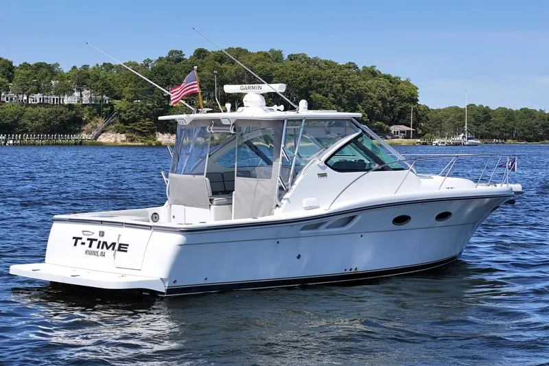 T-time Yacht Photos Pics 2006 Tiara 3200 Open yacht on water, featuring sleek design and American flag.