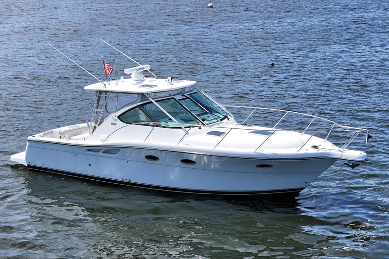 T-time Yacht Photos Pics 2006 Tiara 3200 Open yacht on calm water, featuring sleek design and American flag.