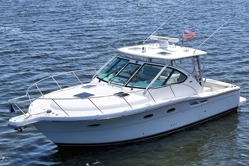 T-time Yacht Photos Pics 2006 Tiara 3200 Open yacht on calm water, featuring sleek design and American flag.